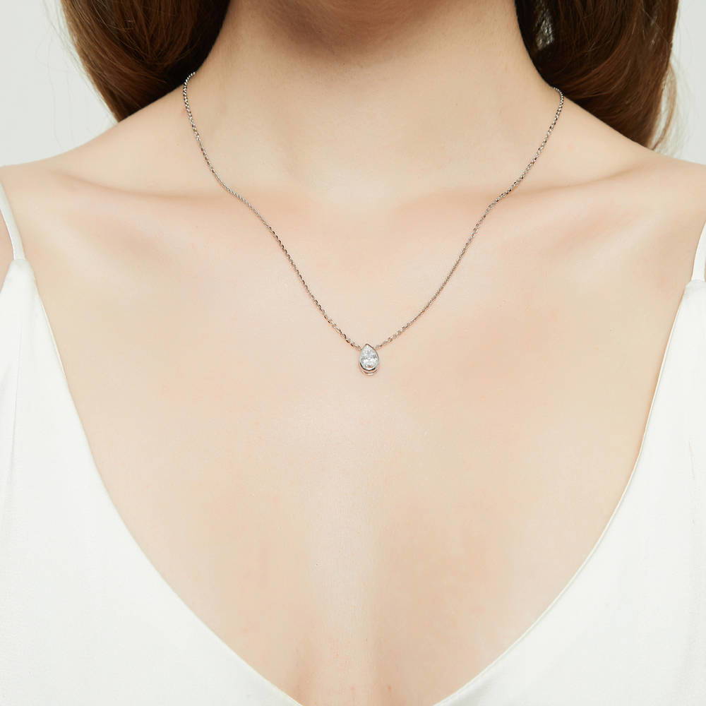 Model wearing Solitaire Bezel Set Pear CZ Pendant Necklace in Sterling Silver 0.8ct, 2 of 6