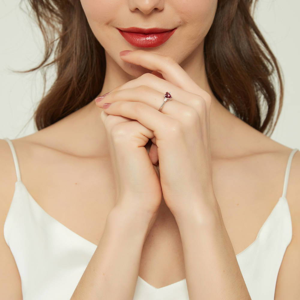 Model wearing 3-Stone Heart Red CZ Ring in Sterling Silver