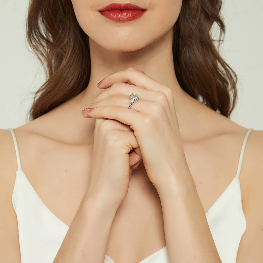 Model wearing 3-Stone Step Emerald Cut CZ Ring in Sterling Silver