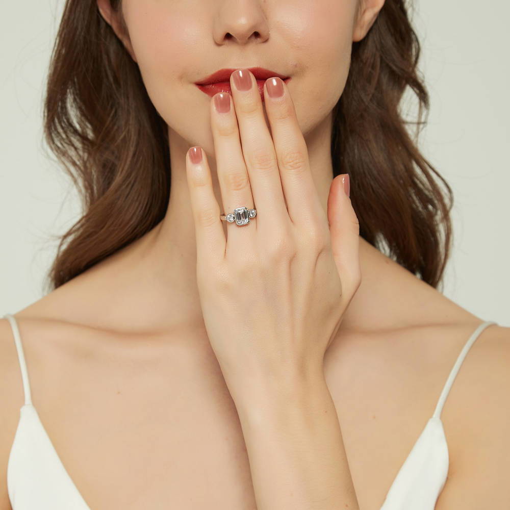 Model wearing 3-Stone Step Emerald Cut CZ Ring in Sterling Silver