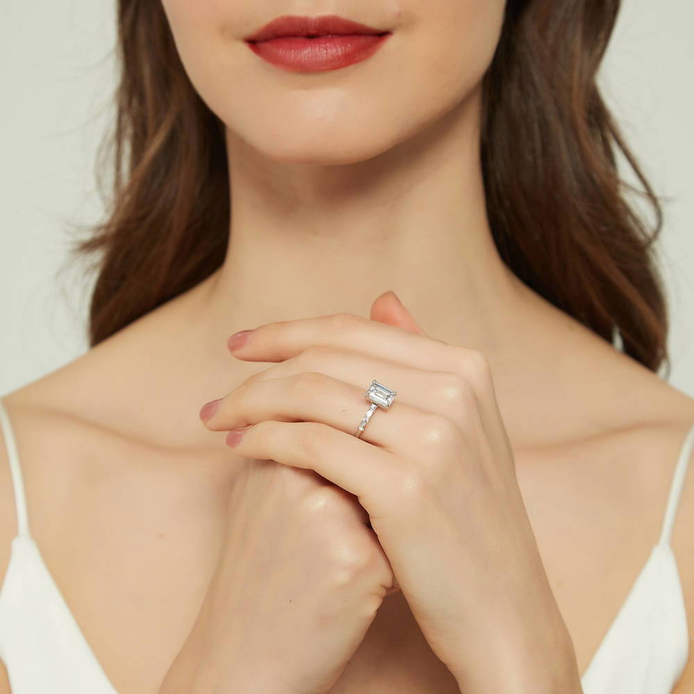 Model wearing Solitaire Art Deco 2.1ct Emerald Cut CZ Ring in Sterling Silver