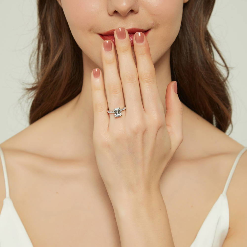Model wearing Solitaire Art Deco 2.1ct Emerald Cut CZ Ring in Sterling Silver