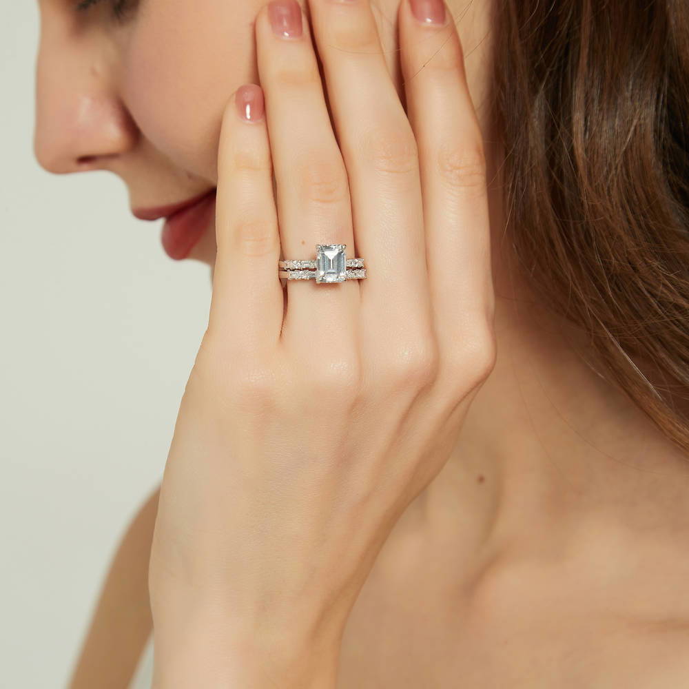 Model wearing Solitaire Art Deco 2.1ct Emerald Cut CZ Ring Set in Sterling Silver