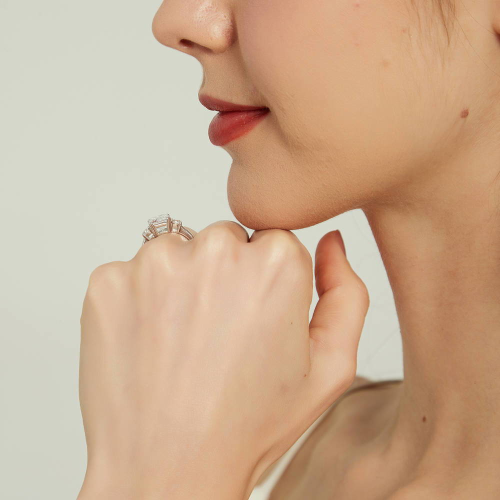 Model wearing 3-Stone Emerald Cut CZ Ring in Sterling Silver