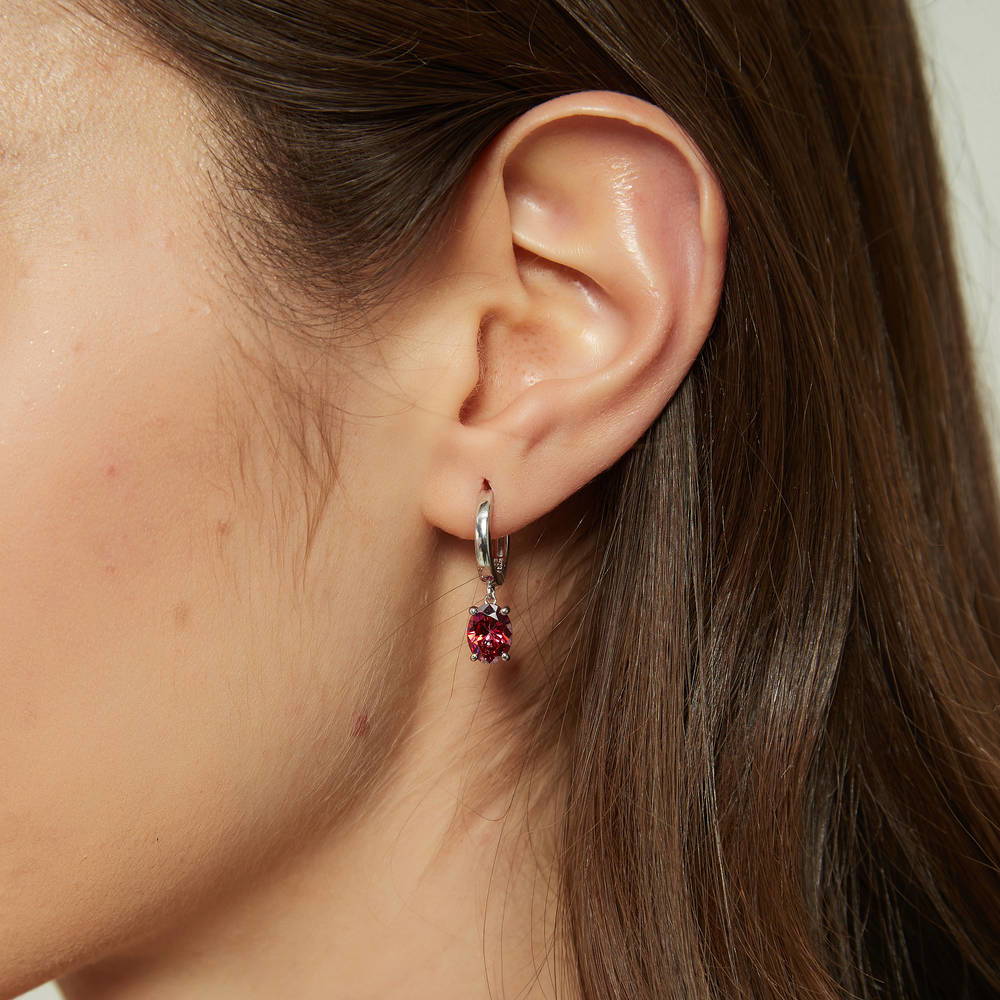 Model wearing Solitaire Red Oval CZ Dangle Earrings in Sterling Silver 2.4ct