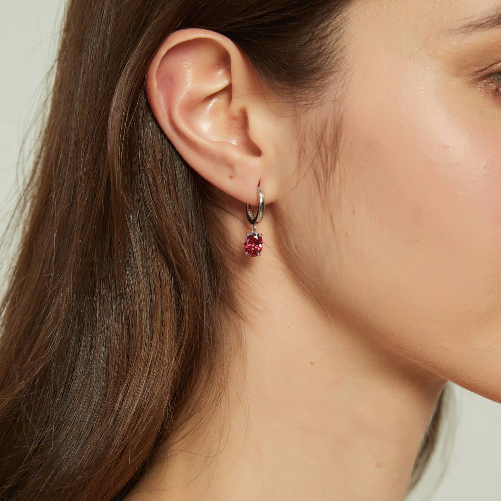 Model wearing Solitaire Red Oval CZ Dangle Earrings in Sterling Silver 2.4ct