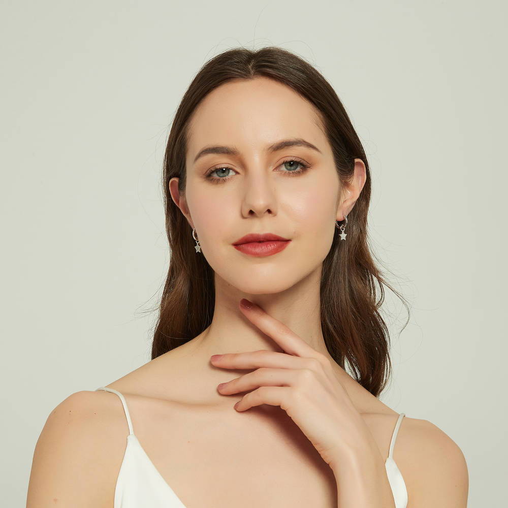 Model wearing Star CZ Dangle Earrings in Sterling Silver