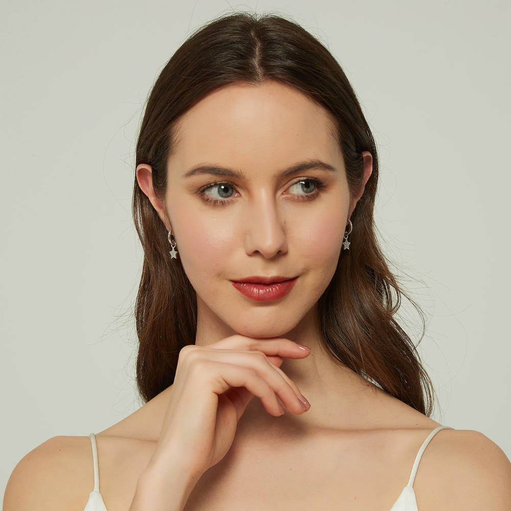 Model wearing Star CZ Dangle Earrings in Sterling Silver