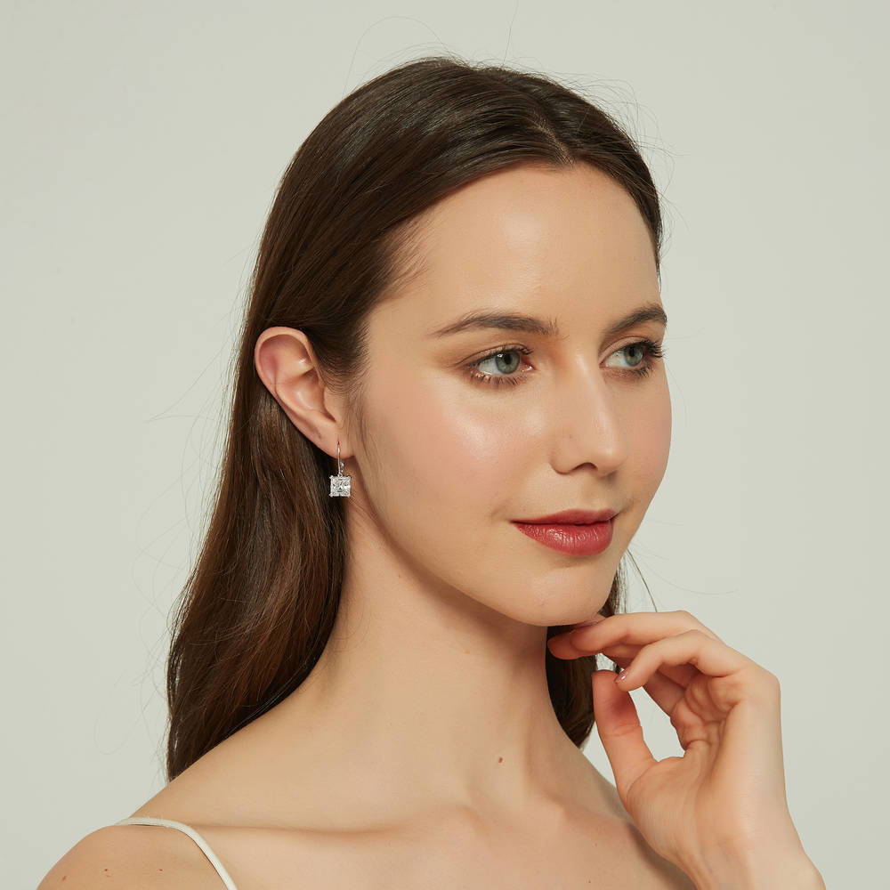 Model wearing Solitaire 6ct Princess CZ Leverback Dangle Earrings in Sterling Silver