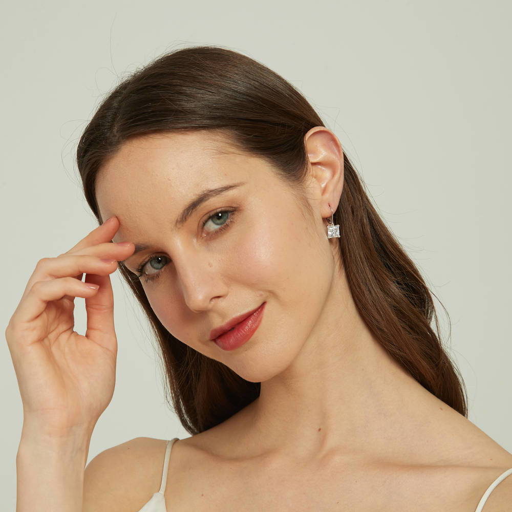 Model wearing Solitaire 6ct Princess CZ Leverback Dangle Earrings in Sterling Silver