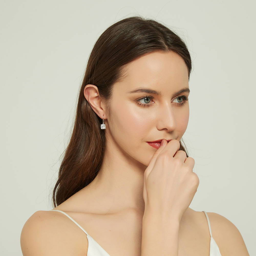 Model wearing Solitaire 6ct Cushion CZ Leverback Dangle Earrings in Sterling Silver