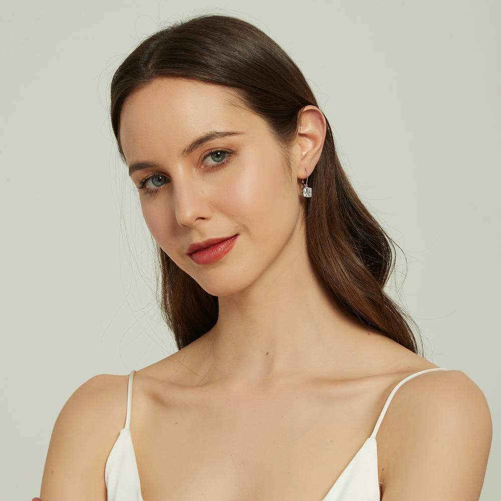 Model wearing Solitaire 6ct Cushion CZ Leverback Dangle Earrings in Sterling Silver