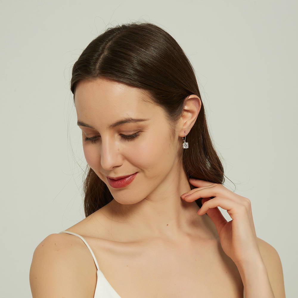 Model wearing Solitaire 6ct Cushion CZ Leverback Dangle Earrings in Sterling Silver