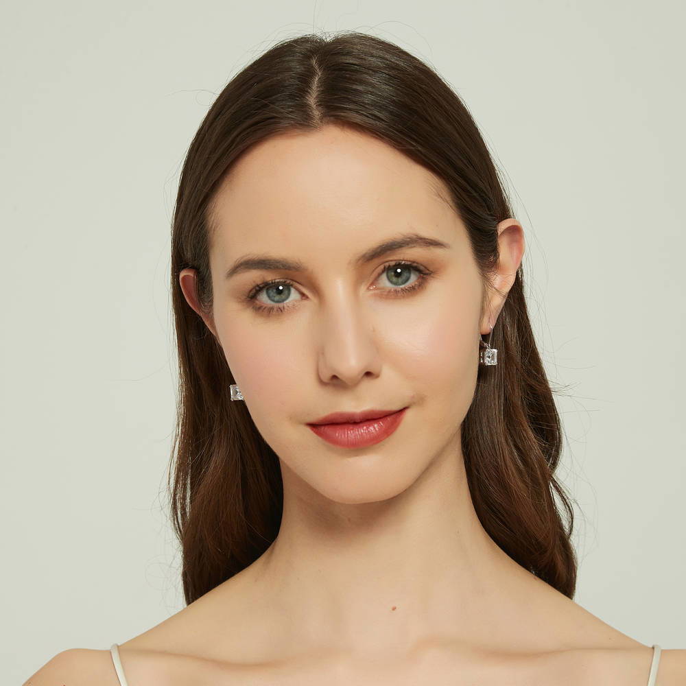 Model wearing Solitaire 6ct Asscher CZ Leverback Dangle Earrings in Sterling Silver