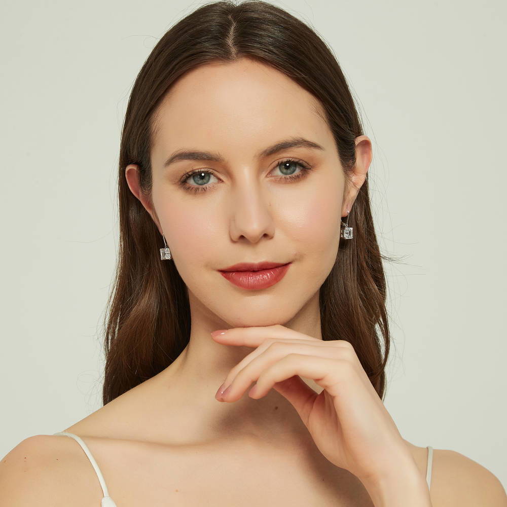 Model wearing Solitaire 6ct Asscher CZ Leverback Dangle Earrings in Sterling Silver