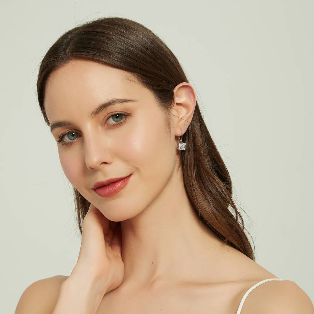 Model wearing Solitaire 6ct Asscher CZ Leverback Dangle Earrings in Sterling Silver