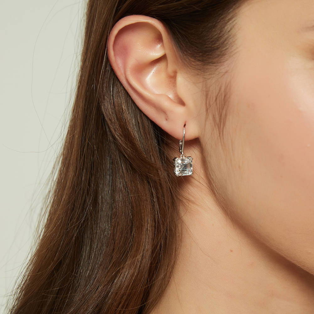 Model wearing Solitaire 6ct Asscher CZ Leverback Dangle Earrings in Sterling Silver