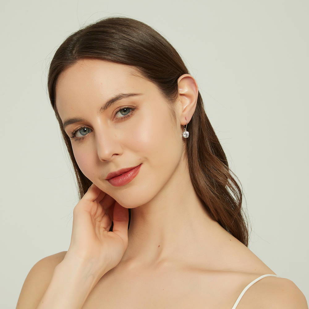 Model wearing Solitaire 4ct Round CZ Leverback Dangle Earrings in Sterling Silver, 5 of 6