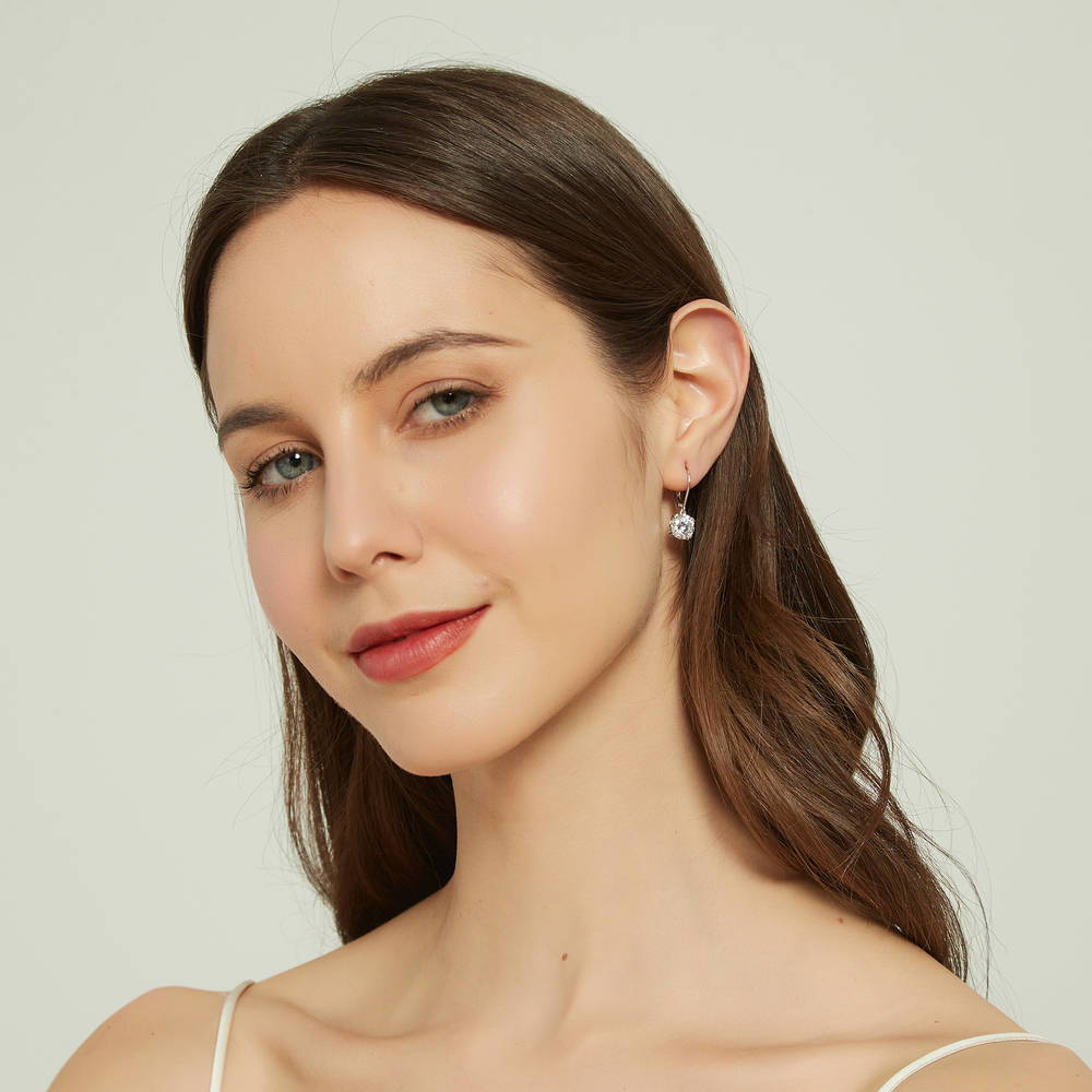 Model wearing Solitaire 4ct Round CZ Leverback Dangle Earrings in Sterling Silver, 3 of 6