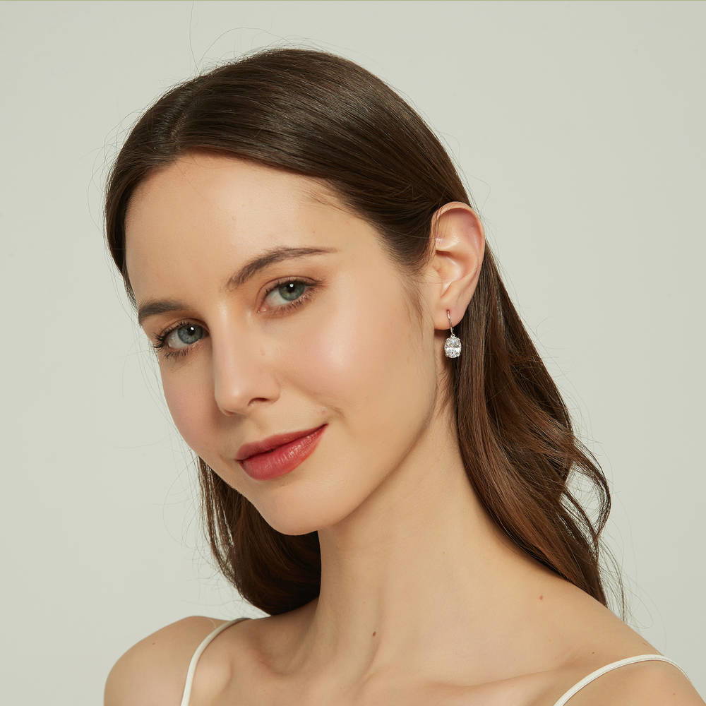 Model wearing Solitaire 5.6ct Oval CZ Leverback Dangle Earrings in Sterling Silver