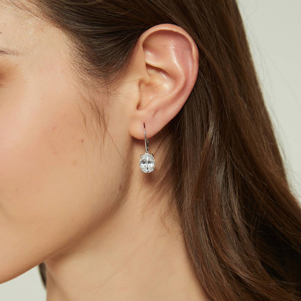 Model wearing Solitaire 5.6ct Oval CZ Leverback Dangle Earrings in Sterling Silver