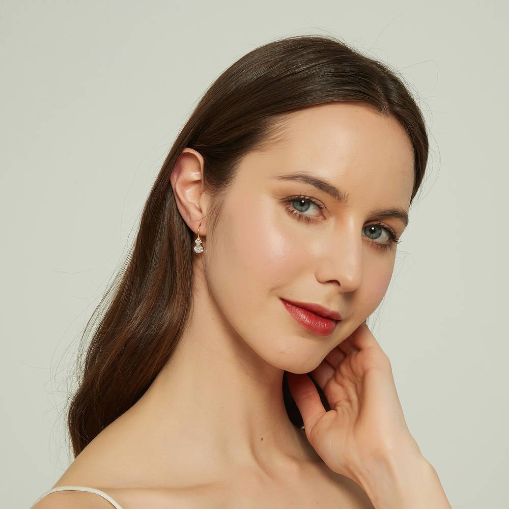 Model wearing 2-Stone CZ Leverback Earrings in Sterling Silver, Yellow Gold Flashed