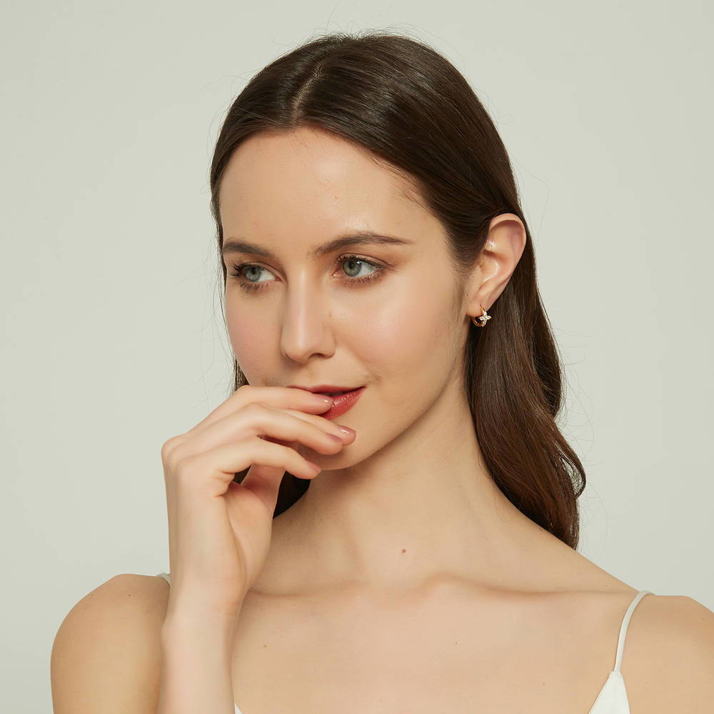 Model wearing Cross CZ Mini Huggie Earrings in Sterling Silver 0.5 inch, Gold Flashed