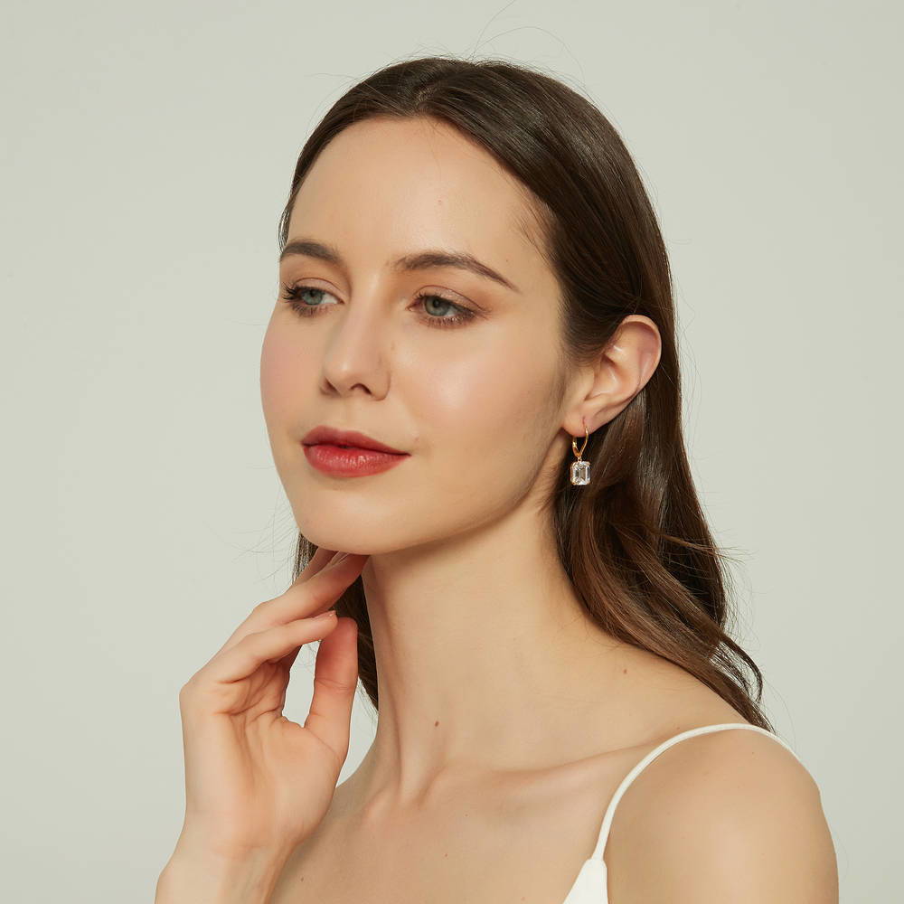 Model wearing Solitaire 7.6ct Emerald Cut CZ Leverback Earrings in Sterling Silver