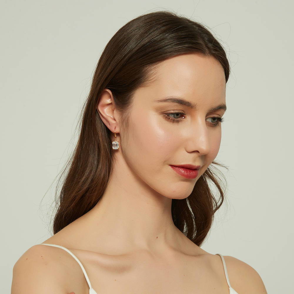 Model wearing Solitaire 7.6ct Emerald Cut CZ Leverback Earrings in Sterling Silver