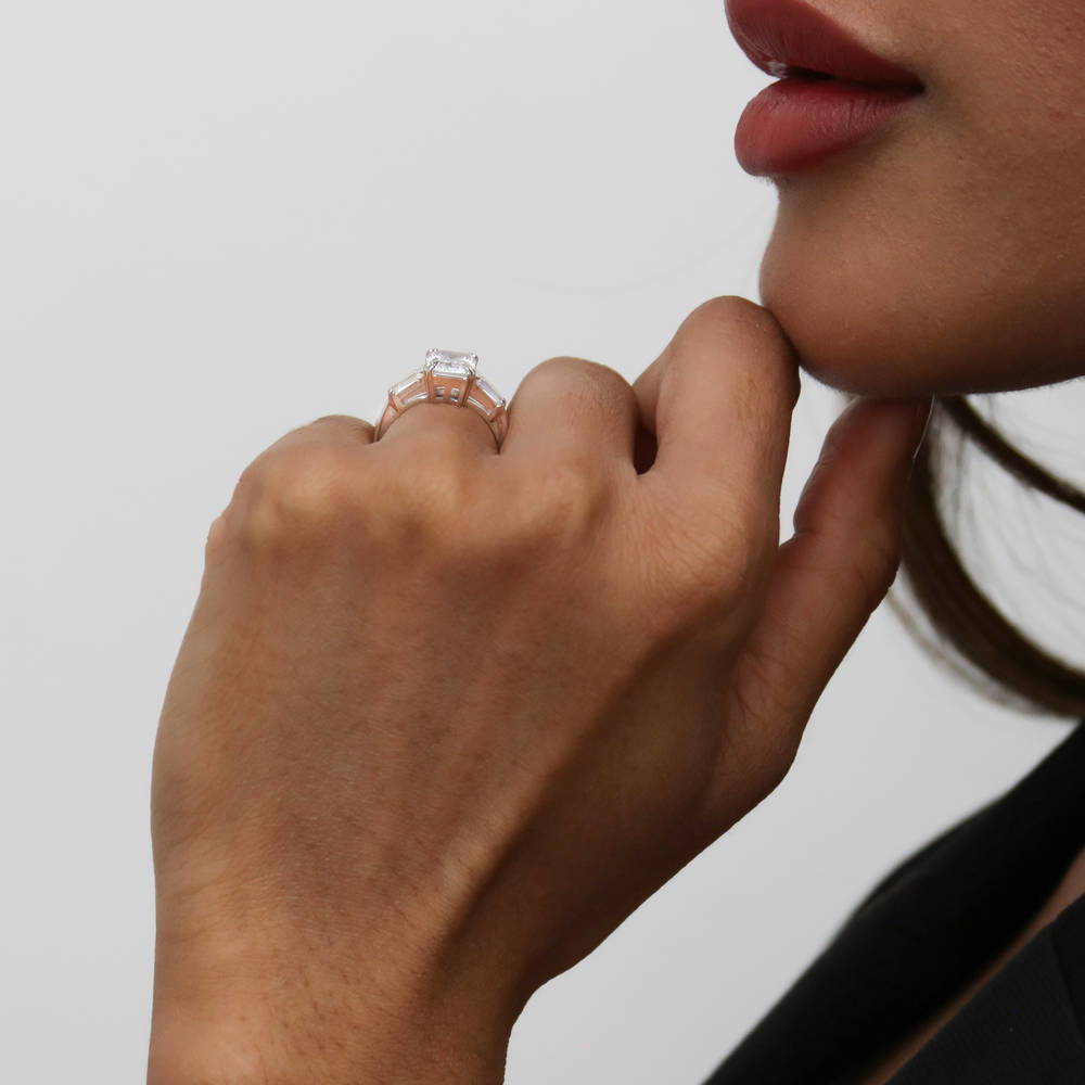 Model wearing 3-Stone Emerald Cut CZ Ring in Sterling Silver