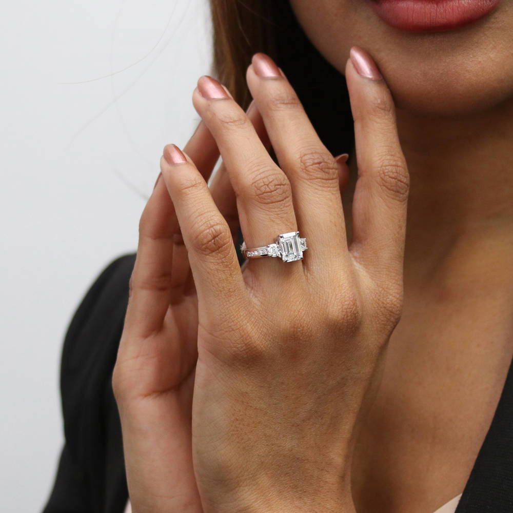 Model wearing 3-Stone Emerald Cut CZ Ring in Sterling Silver