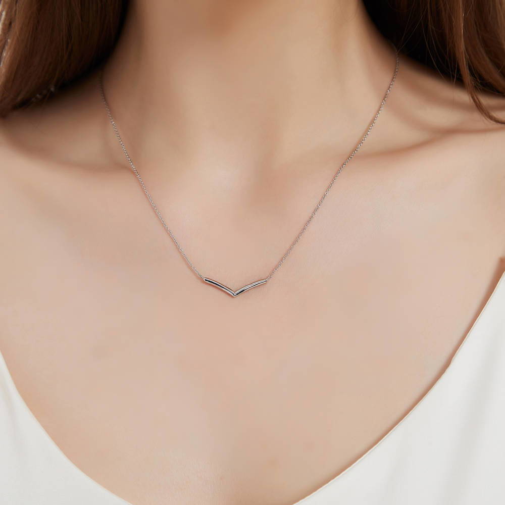 Model wearing Wishbone Chevron Pendant Necklace in Sterling Silver