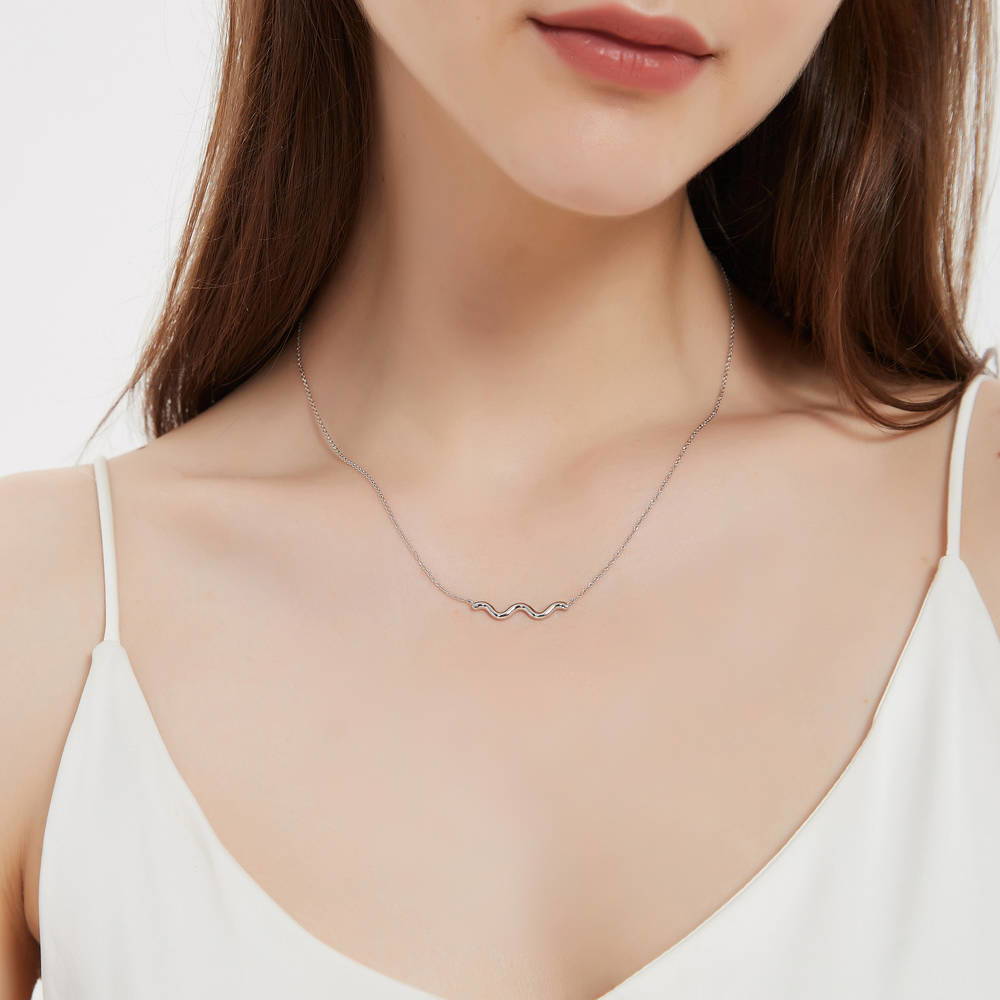 Model wearing Wave Pendant Necklace in Sterling Silver