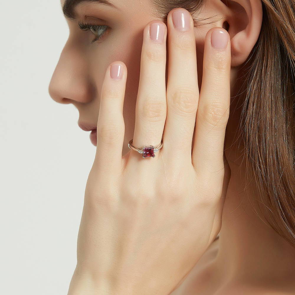 Model wearing 3-Stone Red Princess CZ Ring in Sterling Silver