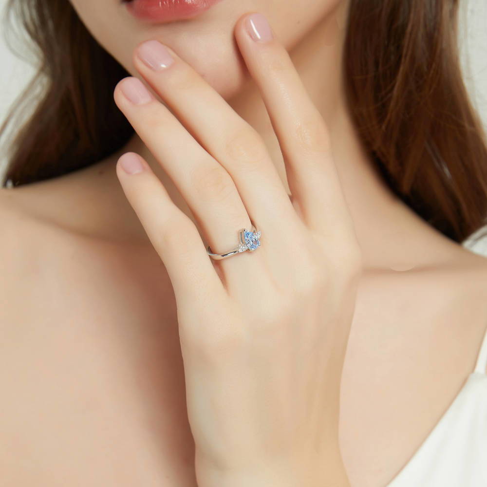 Model wearing 3-Stone Greyish Blue Pear CZ Ring in Sterling Silver