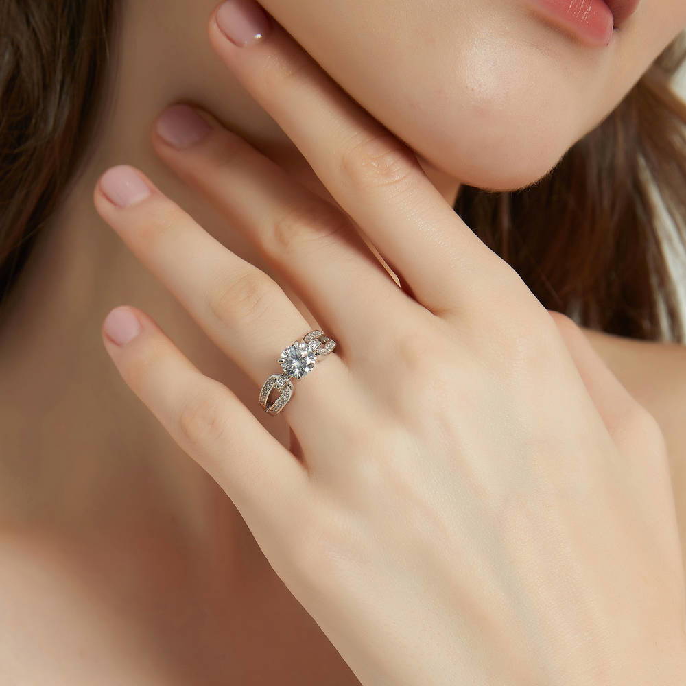 Model wearing Solitaire Interlocking 1.25ct Round CZ Ring in Sterling Silver, 3 of 9