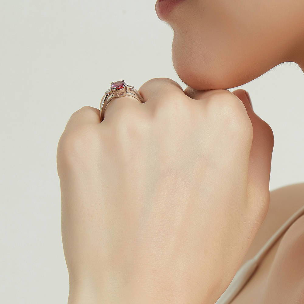 Model wearing 3-Stone Red Oval CZ Ring in Sterling Silver