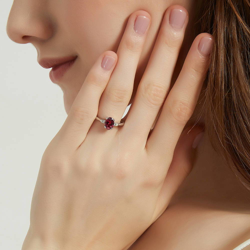 Model wearing 3-Stone Red Oval CZ Ring in Sterling Silver