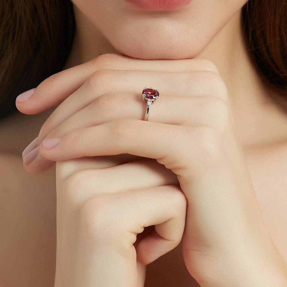 Model wearing 3-Stone Red Oval CZ Ring in Sterling Silver