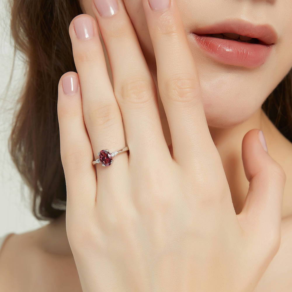 Model wearing 3-Stone Red Oval CZ Ring in Sterling Silver