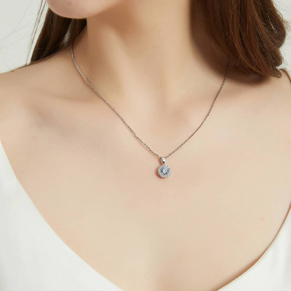 Model wearing Halo Greyish Blue Round CZ Pendant Necklace in Sterling Silver