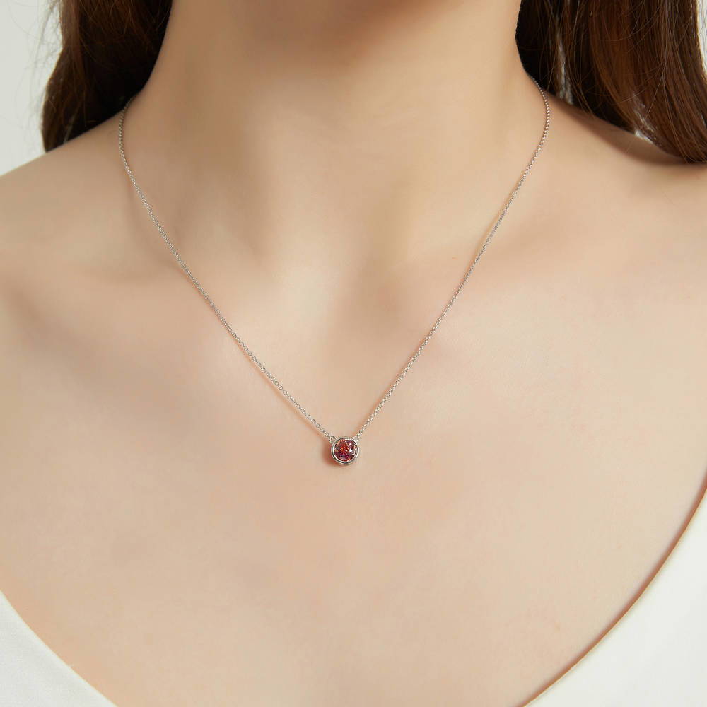 Model wearing Solitaire Red Orange Bezel Set Round CZ Set in Sterling Silver