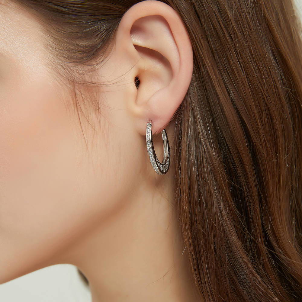 Model wearing Oval Bar CZ Medium Hoop Earrings in Sterling Silver 1 inch