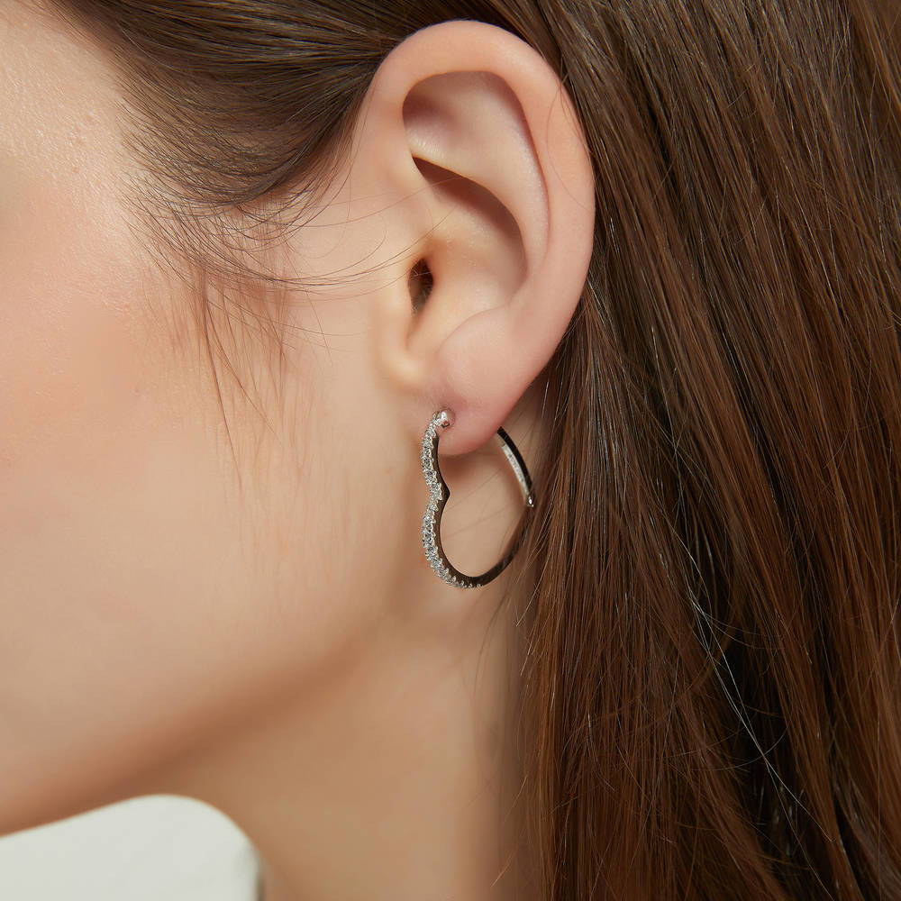 Model wearing Heart CZ Medium Hoop Earrings in Sterling Silver 1 inch