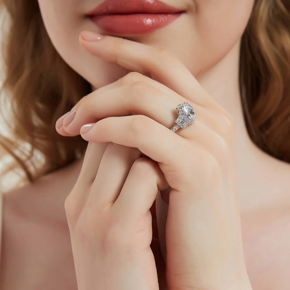 Model wearing 3-Stone Halo Pear CZ Ring in Sterling Silver