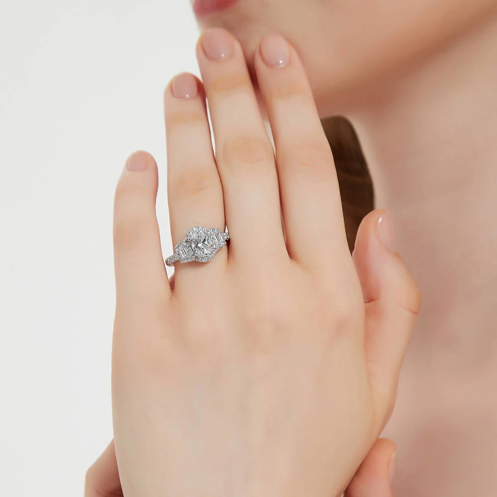 Model wearing 3-Stone Halo Oval CZ Ring in Sterling Silver