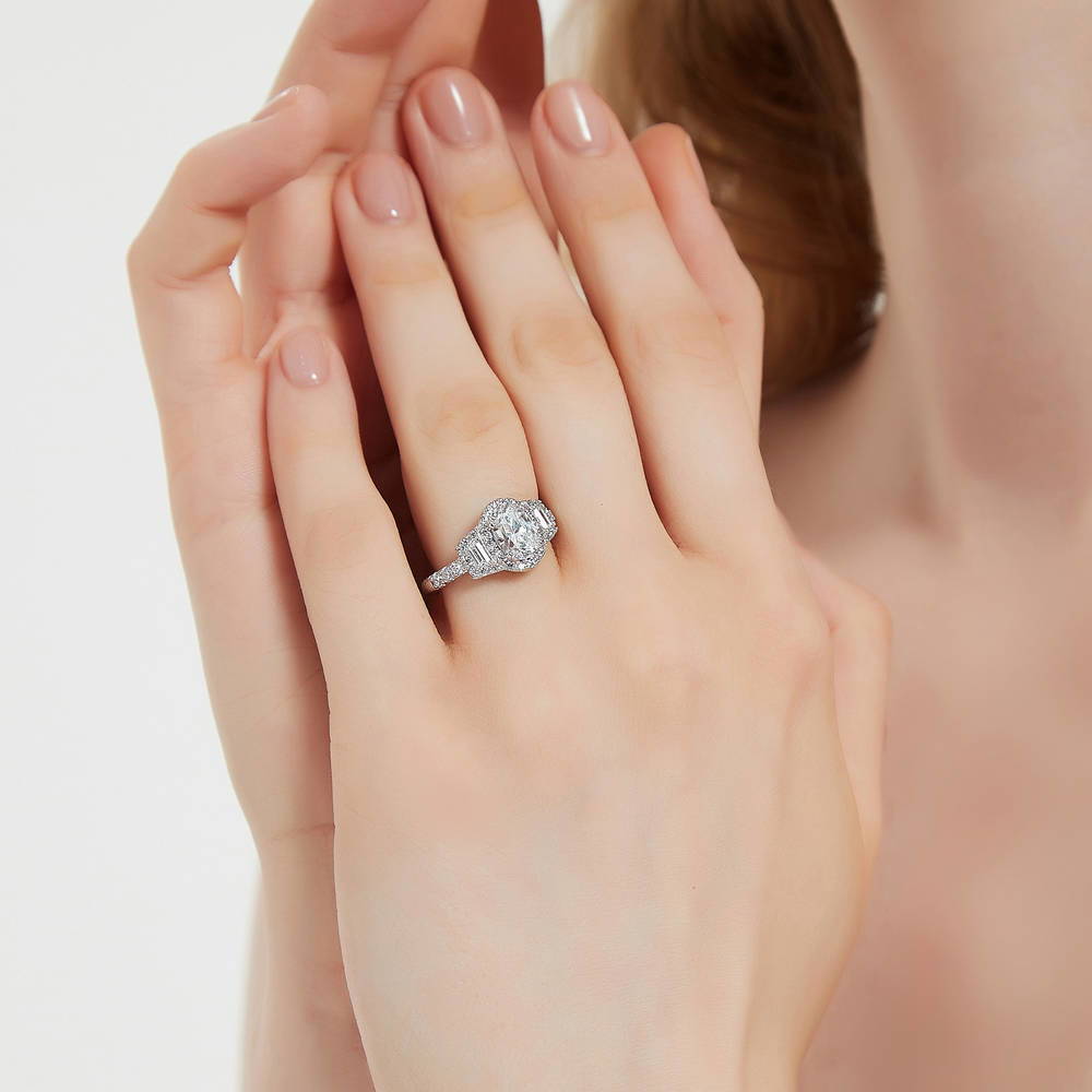 Model wearing 3-Stone Halo Oval CZ Ring in Sterling Silver