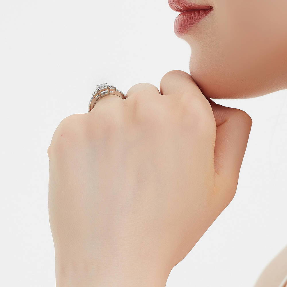 Model wearing 3-Stone Emerald Cut CZ Ring in Sterling Silver