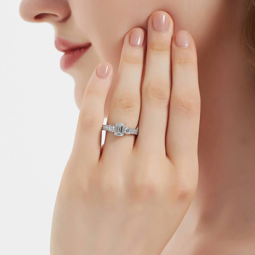 Model wearing 3-Stone Emerald Cut CZ Ring in Sterling Silver