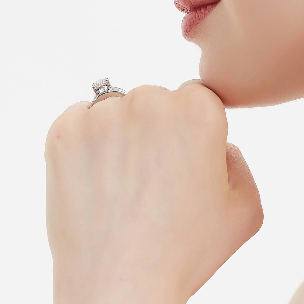 Model wearing Solitaire 2.5ct Oval CZ Ring Set in Sterling Silver